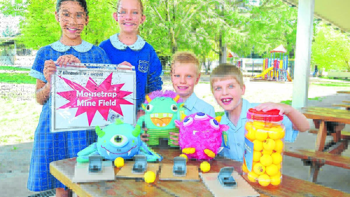 PLAY IF YOU DARE: Bletchington Public School year 5 students Sarah Gee, Claudia Frost, Lawson Hamling and Isaac Saunders invite you to their mousetrap mine field stall at tonight's event. Photo: JUDE KEOGH 0306bletchbash1