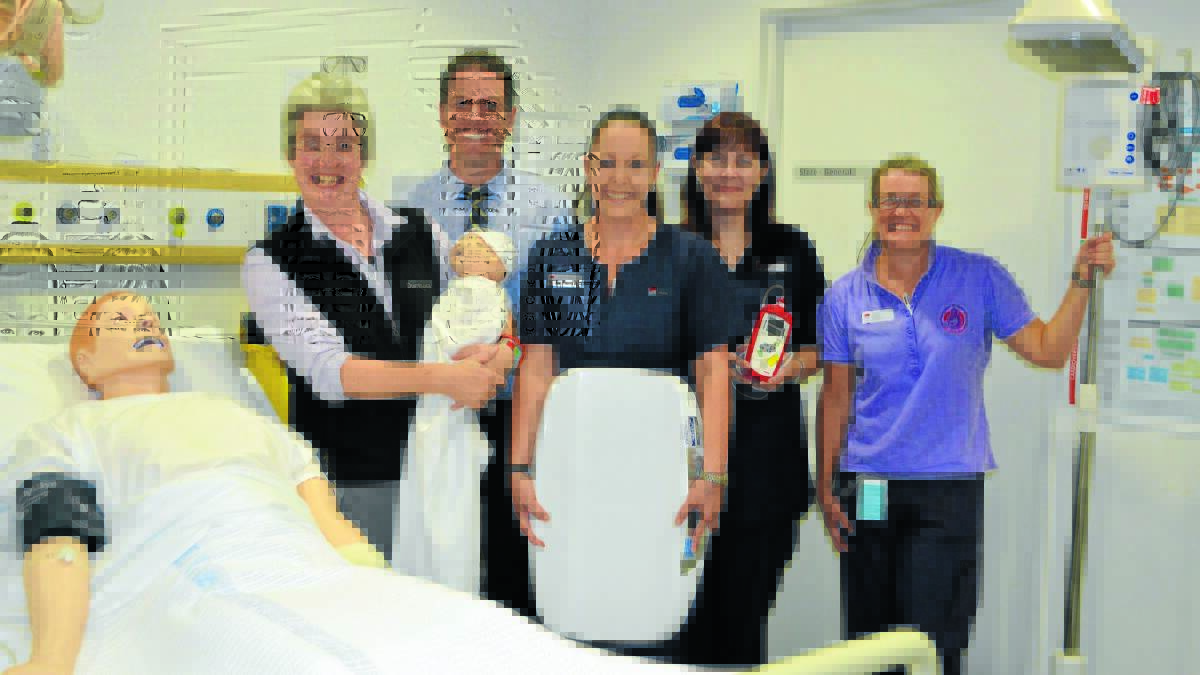 HELPING HANDS: Paediatrician Dr Jo Rainbow with Peter McCormack, emergency clinical nurse educator Cathy Whiteman, Group Practice midwife Jenny Soar and Group Practice clinical midwife Danielle Syme and some of the equipment they have bought with money raised from the New Year’s Eve party. Photo: TANYA MARSCHKE. 1218tmhospdonation3.
