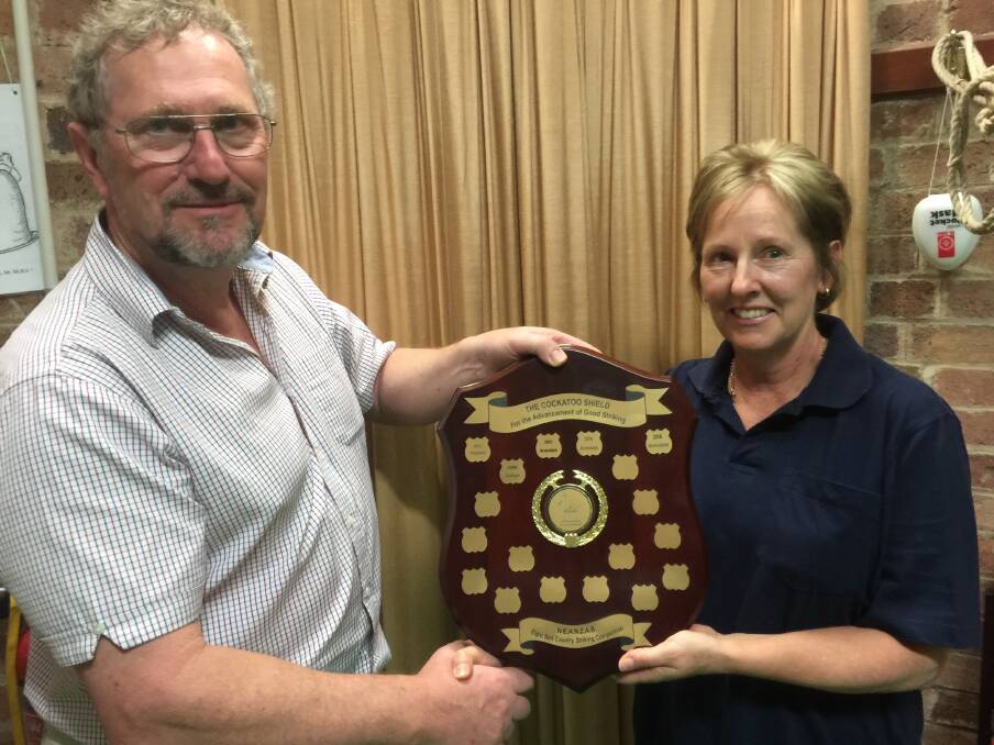 RINGING WIN: Australian New Zealand Association of Bellringers president David Smith presenting the Cockatoo Shield to Orange Pealers tower captain Sheena Snowdon. Photo: CONTRIBUTED