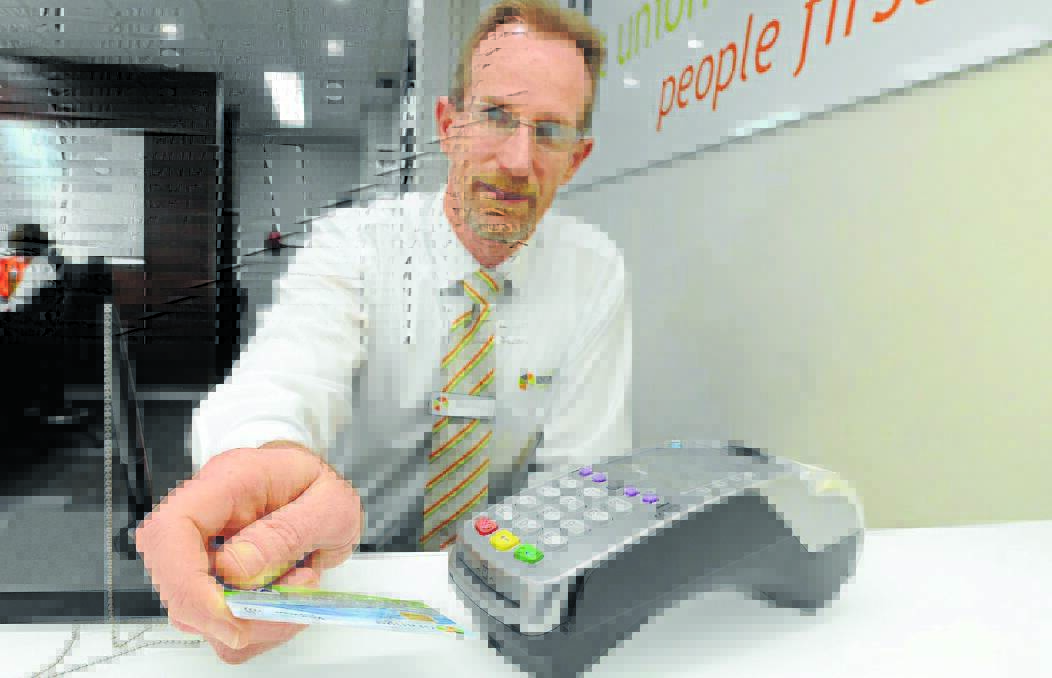 LETTERS TO DIGITS: Orange Credit Union retail services manager Glenn Tracey believes the transition to PIN-only card transactions will be smooth tomorrow. Photo: STEVE GOSCH
