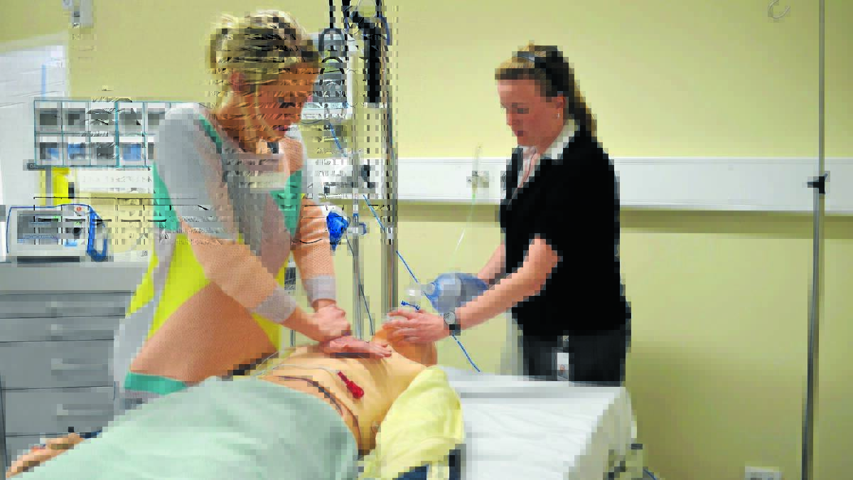 HANDS-ON EXPERIENCE: Medical Students Hannah Laughton and Emma Moloney carry out a simulated resuscitation of a medical manikin after a scenario of cardiac arrest.Photo: JANICE HARRIS0731syduni
