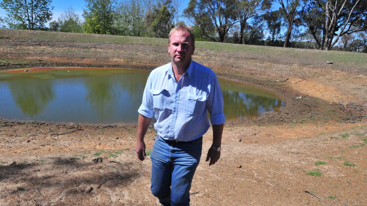 HIT AND MISS: NSW Department of Primary Industry’s (DPI) technical specialist in grain services Peter Matthews standing next to one of the dams on the DPI’s Forest Road properties says the recent rainfall will have pleased some growers but not all. Photo: JUDE KEOGH. 3pm Friday.

