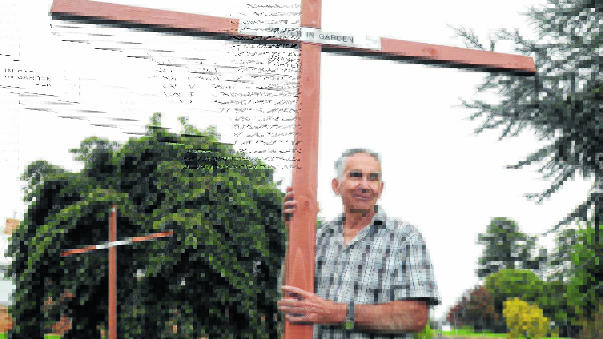 KEEPING THE FAITH: Pat Frecklington holds one of the 14 crosses that represent the stages of Jesus’s final journey. 						           Photo: STEVE GOSCH 0410sgcross1 
