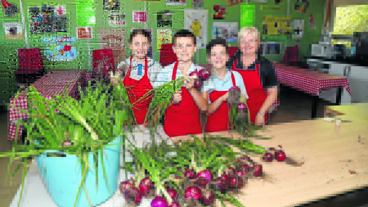 MASTERCHEFS IN THE MAKING: Phoebe Constable, James Fowler, Dylan Cregan and kitchen assisstant Denise Leahy in the kitchen at Calare School. 
Photo: Phil Blatch
