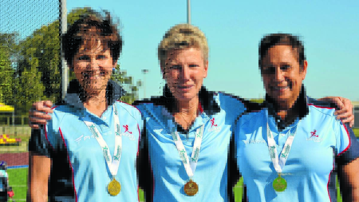 BLUES: Kerrie Wood, Jane Rowlands and Deb Orrock enjoy the spoils of victory at the Australian Masters Championships in Brisbane. Photo contributed.