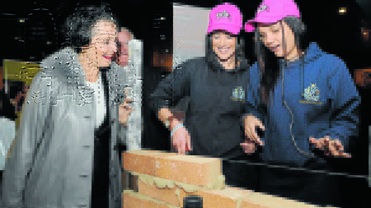 FOR THEMSELVES: Minister for Women Pru Goward looks on as Olivia Arnold and Teoni McGovern try their hand at bricklaying.
Photo: STEVE GOSCH 0731sgjobs1