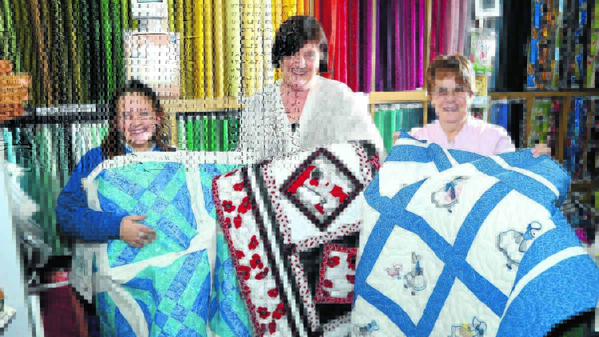 WORK OF ART: Chelsea Forte, 9, Jean Evers and Dawn Davis are entering quilts into the Orange Show that is taking place this weekend. 
Photo: PHIL BLATCH                                                                                                                                                                                                                                                                                                   