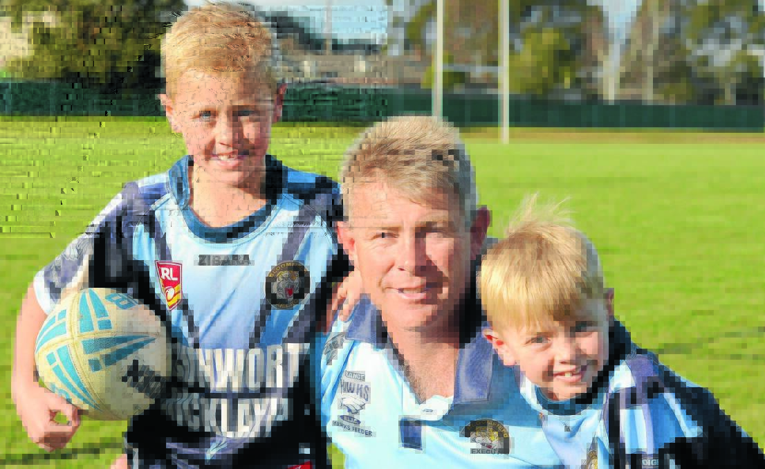 SUPER DAD: Harry and Jack Greenhalgh love their dad Jason, who this year won the Philips community sports dad of the year award. Photo: JUDE KEOGH                                     
