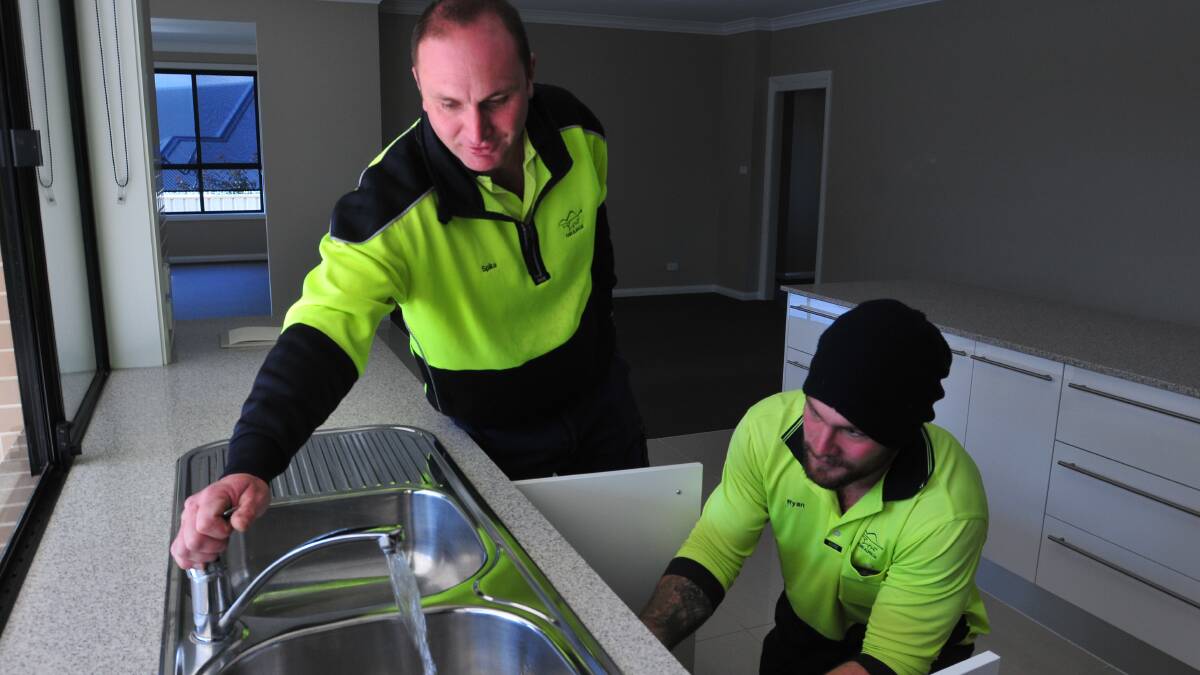 ON TAP: Orange City Council utilities officers Graeme Bryant and Ryan Davis test the water at Murray Avenue in June last year. 
Photo: JUDE KEOGH  