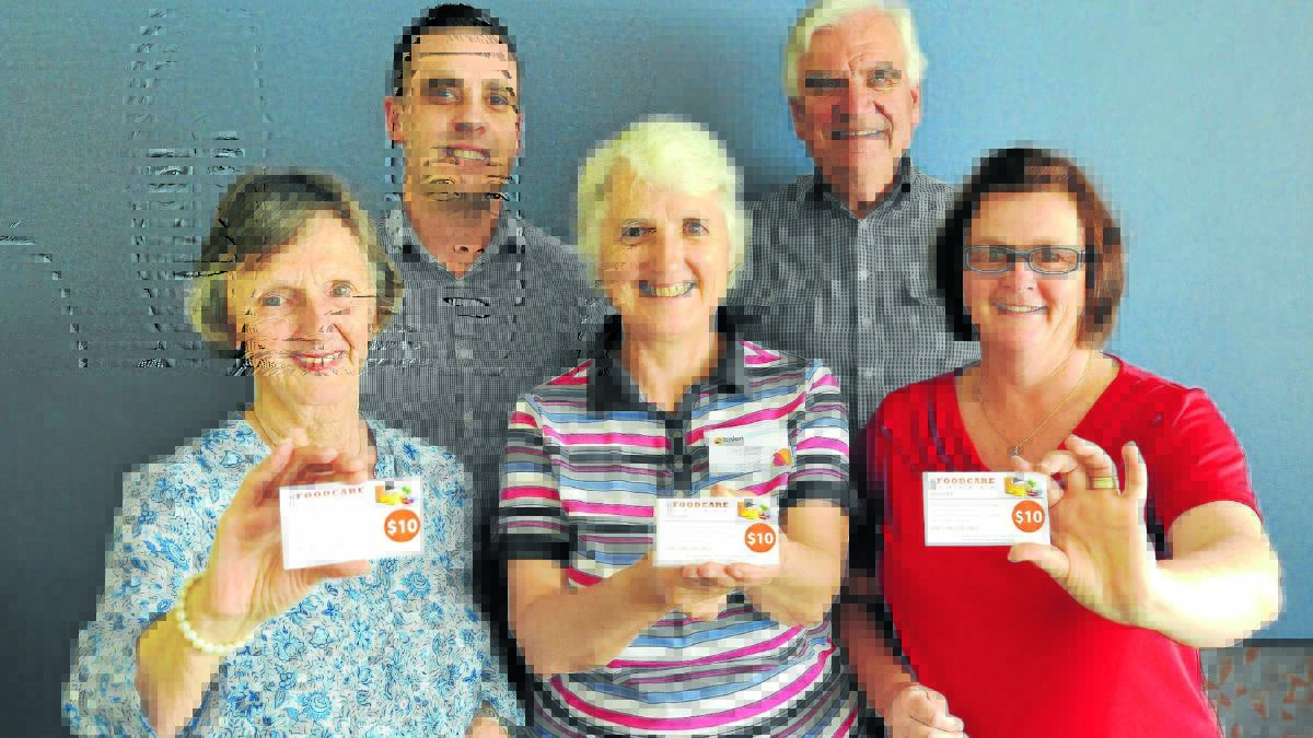 WORTH VOUCHING FOR: FoodCare Orange committee member Anne Hopwood with Housing Plus chief operating officer Steve Stanton, Fusion’s Bev Rankin, FoodCare treasurer Rob Campbell and Lyndon Community case worker Cathy Elward holding the new FoodCare vouchers. 
Photo: STEVE GOSCH  