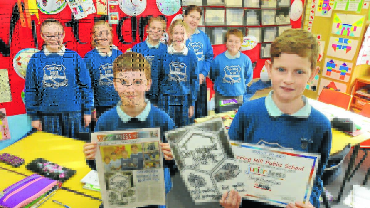 PRESS GURUS: Spring Hill Public School students Zali Whybrow, Felicity Palazzi, Sharna Nitto, Cheyanne Thurlow, Lily Gutherson, Jayden Woods and (front) Flynn Magee and Nathan Hines with the school’s award-winning Junior Press ad. Photo: JUDE KEOGH 