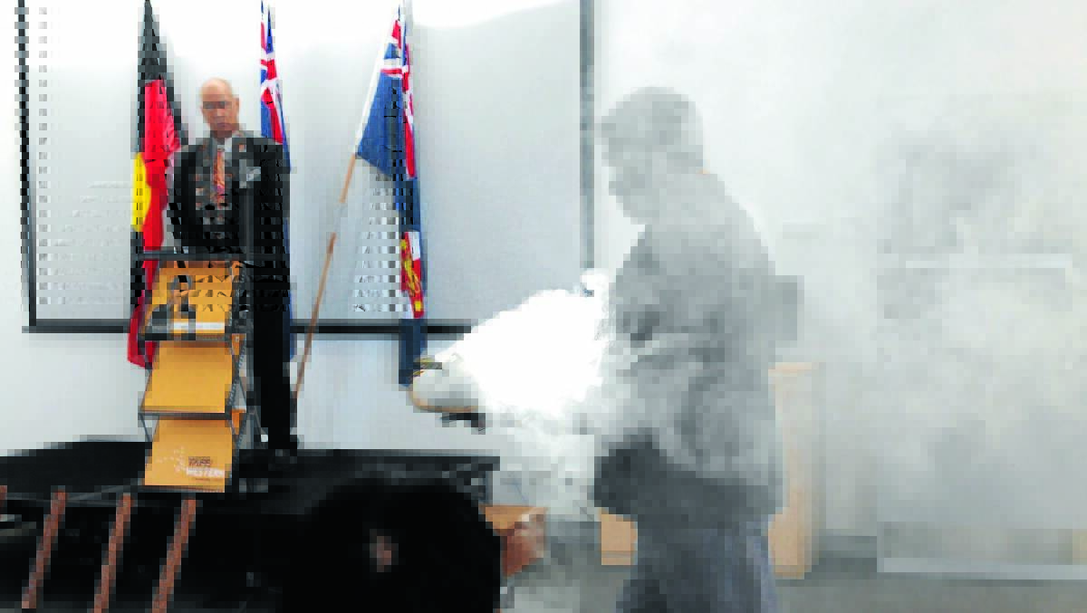 SMOKING GUN: TAFE Western Aboriginal education and equity provision director Rod Towney looks on as Wiradjuri elder Peter Peckham performs a smoking ceremony at the Winhanganha Aboriginal learning centre. 
Photo: STEVE GOSCH 0731sgtafe1