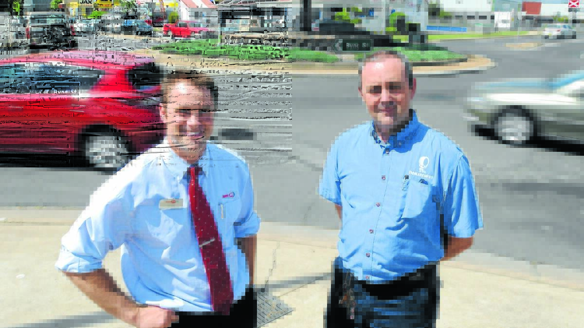ABOUT TIME: Ashcroft's SUPA IGA store manager Adam Ashcroft and Beaurepaires store manager Troy Gowen. Photo: JUDE KEOGH  