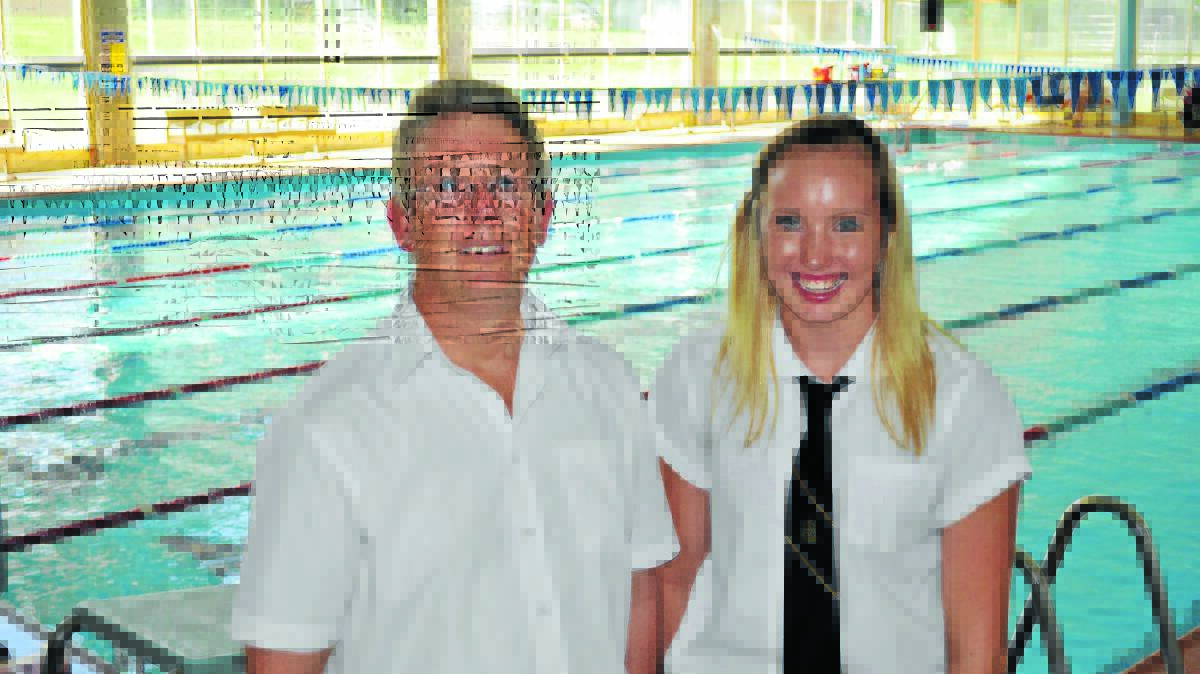 SPLISH SPLASH: Looking to further build on the work put in throughout training, Courtney Chapman, with swim coach Gary Hollywood, is hoping for a national swimming medal in the future. Photo: NICK McGRATH                                                                                                                                                                                                                                                                                         0224nmswim
