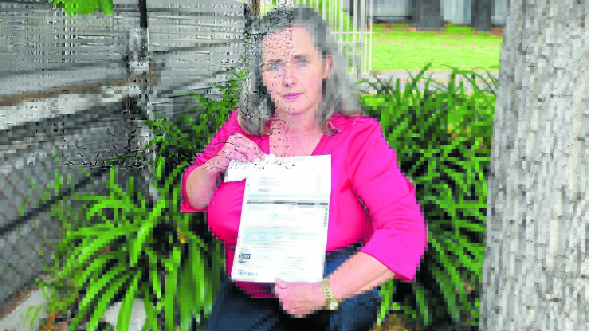IT STINKS: Millthorpe resident Lyn Plummer currently pays for two sewer connections and is struggling to afford them as sewerage rates skyrocket.  Photo: LUKE SCHUYLER  0509lesewer2