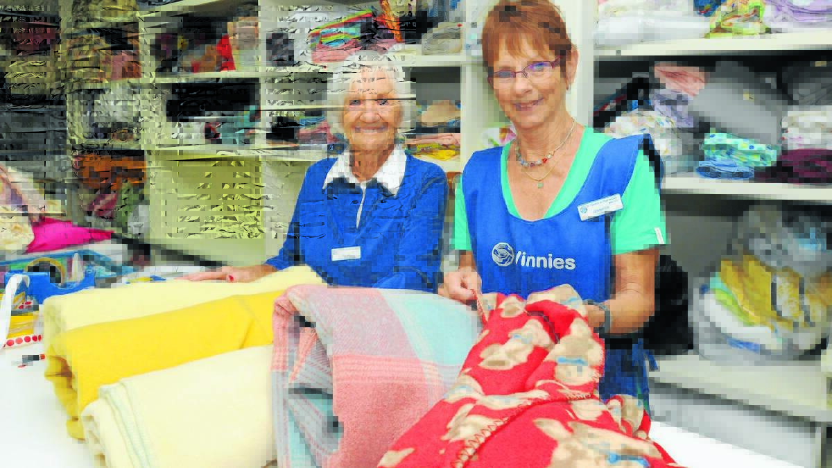 HELP NEEDED: St Vincent de Paul volunteers, including Dulcie Ferguson and Jennifer Murphy, help organise the charity’s stocks for winter. 
Photo: JUDE KEOGH                                                                                                                                              