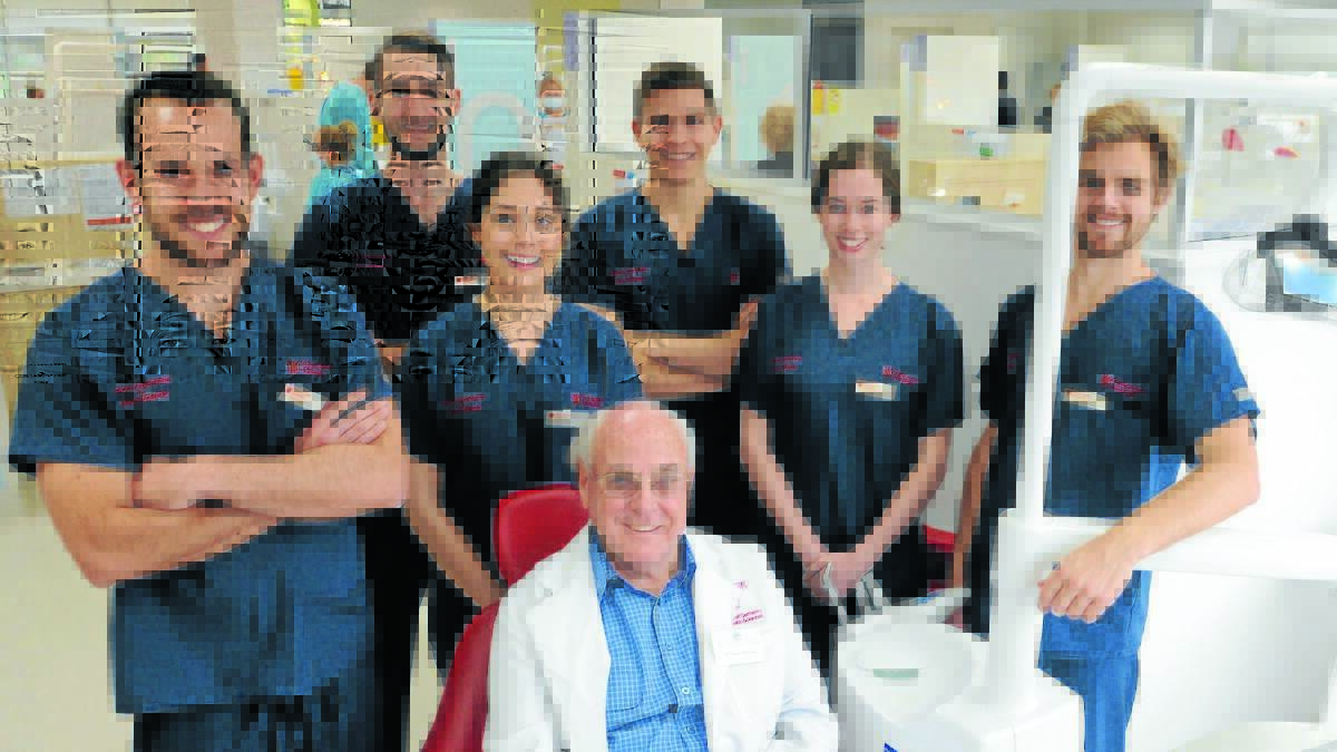 HELPING ORPHANS: Dr Graham McLennan (seated) with Glen Hilton, Eric Cullen, Erin Currier, Daren Vujovic, Caitlin Crowley and Sam Hill from Charles Sturt University Orange who are travelling to Cambodia to treat children in orphanages. Photo: STEVE GOSCH  
