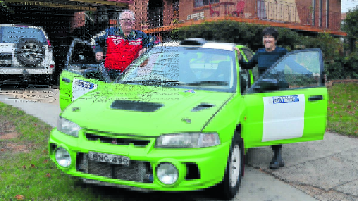 POWER COUPLE: Orange driver John Fraser alongside his wife Ann Fraser who will navigate the pair’s lime green Mitsubishi Evo through Canobolas State Forest as part of the John Giddings Memorial Orange Rally on Saturday. 
Photo: BRYSON FERREIRA.  
