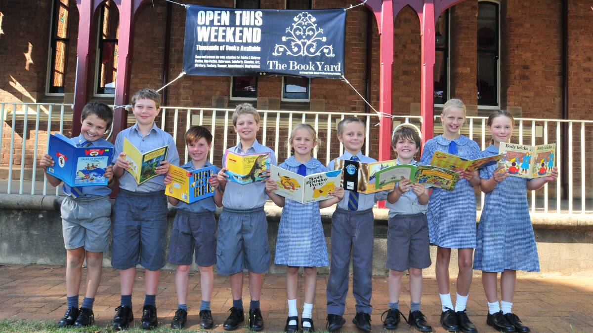 BOOKS FOR A CAUSE: Orange Public School students Griffin Robinson, Darcy Shaw, William Pearce, Ethan Shaw, Aurora Matthews, Heath Robinson, Jack Mahlo, Caitlyn Broadfoot and Lila Pearce invite you to come along to their inaugural Book Yard. Photo: JUDE KEOGH 0205books1