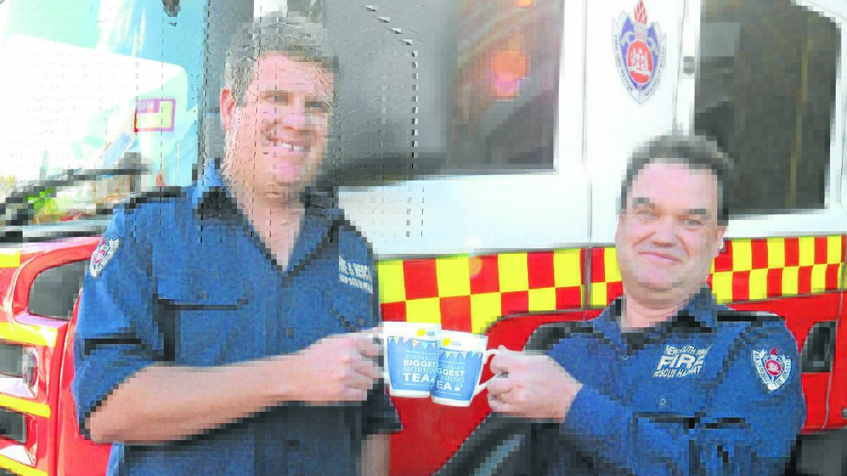 RAISE YOUR CUP: Firefighter Mark Bell and senior firefighter Phil Pedley hope Orange residents will support their open day and raise money for the Cancer Council at the same time.
Photo: STEVE GOSCH  0512sgcuppa4