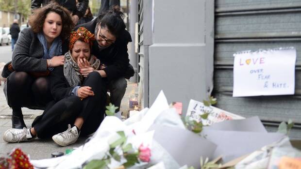 TEARS IN PARIS: A woman cries near the Le Petit Cambodge restaurant, the site of one of the attacks.