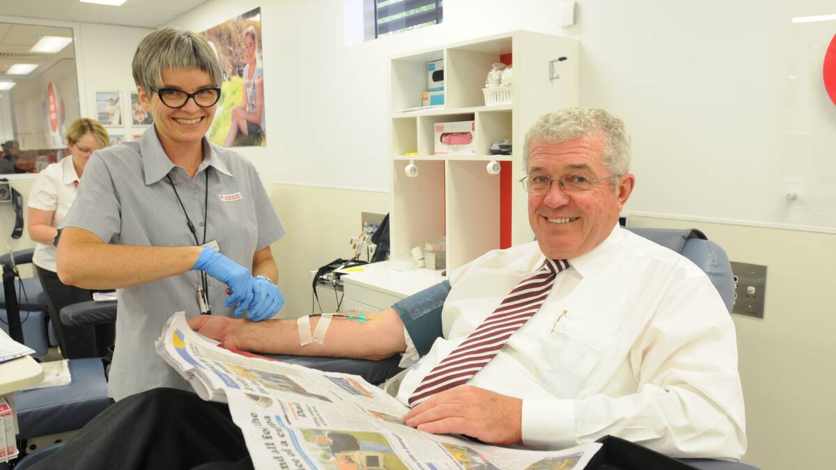 READY TO DONATE: Australian Red Cross Blood Service registered nurse Therese Goodacre helps John Cook to donate plasma. Photo: STEVE GOSCH 