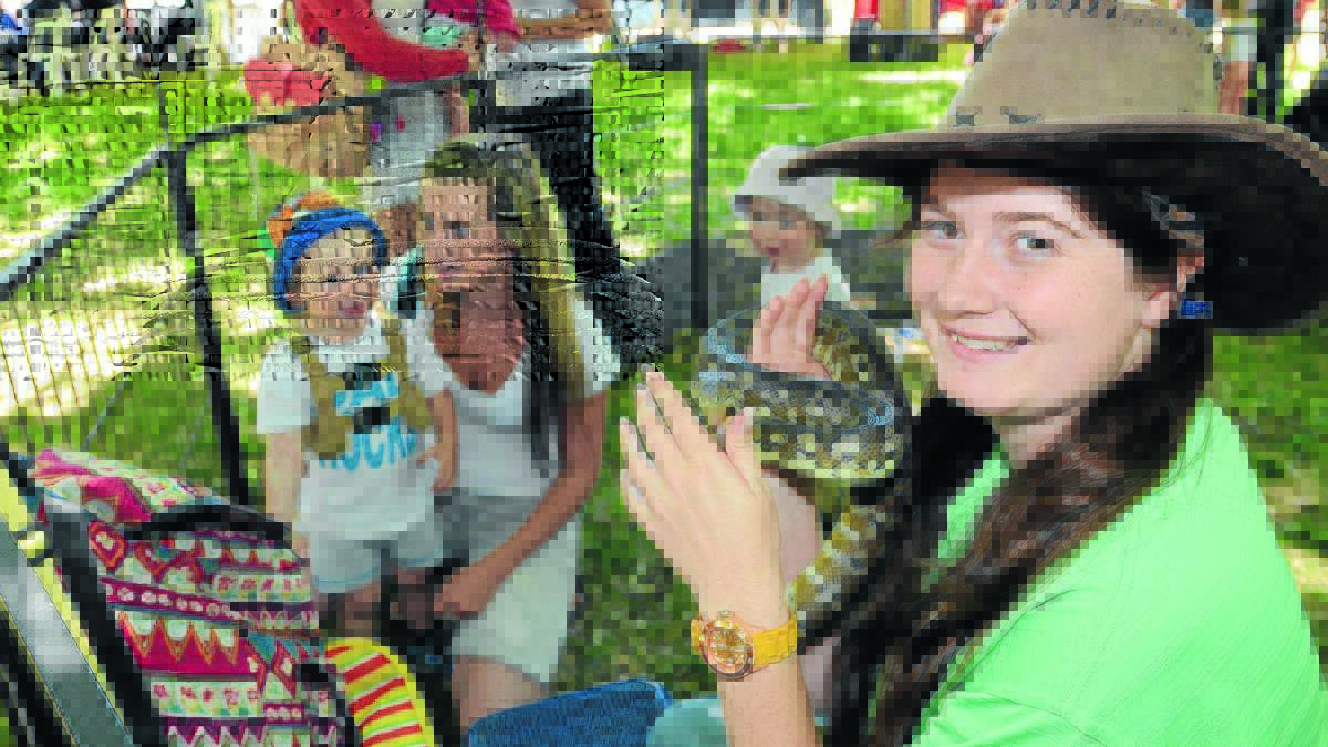 Steph Sayles of Bounty’s Bush Farm showed children a variety of animals including a snake at the NSW Fair Trading community fun day.                                                                                                    1029fairtrade13
