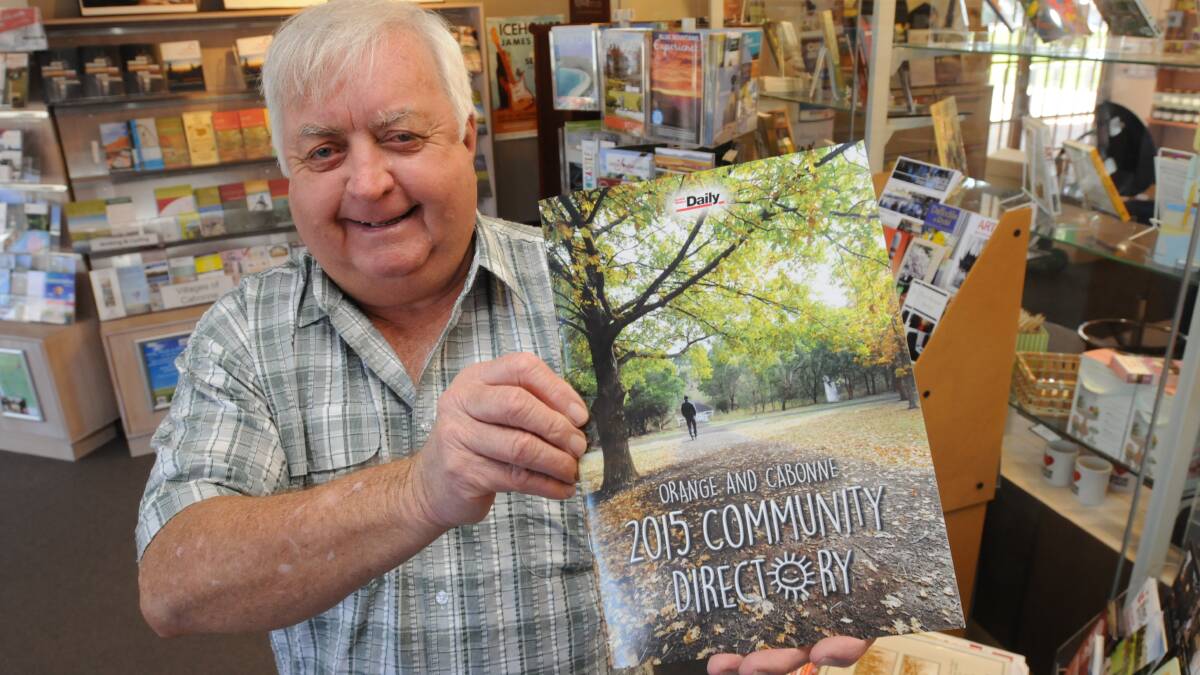 PLEASING READ: Orange City Council services committee chair, councillor Ron Gander showing off the Orange and Cabonne 2015 Community Directory at the Visitor Information Centre. Photo: JUDE KEOGH 