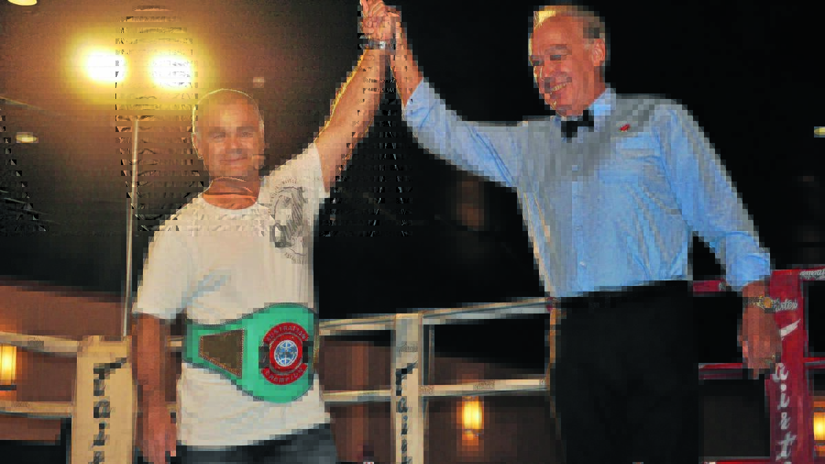 FINALLY: Glenn Sutherland is awarded the Australian junior-lightweight belt, which he won 20 years ago. Photo NICK MCGRATH                                                                                                                                                     0221nmbox19