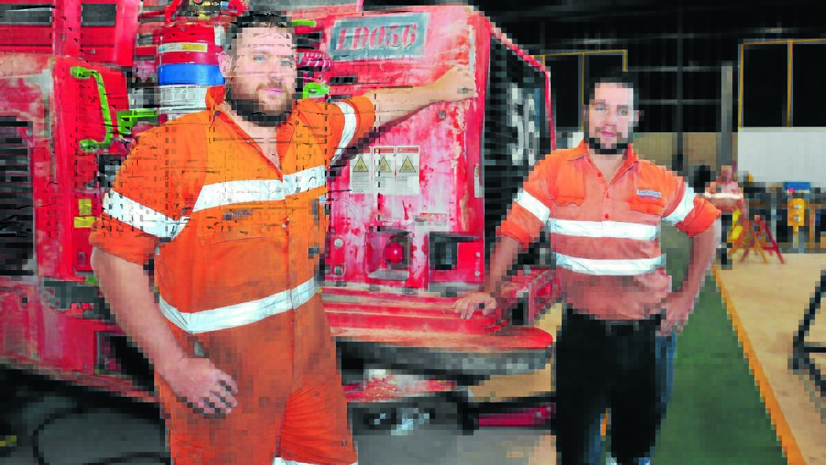 TRICKS OF THE TRADE: Peter Maher and Jamie Marshall who are apprenticed to Whittaker Contracting through the Australian Business Apprenticeships Centre, have gone on to complete dual apprenticeships. Photo: JUDE KEOGH

