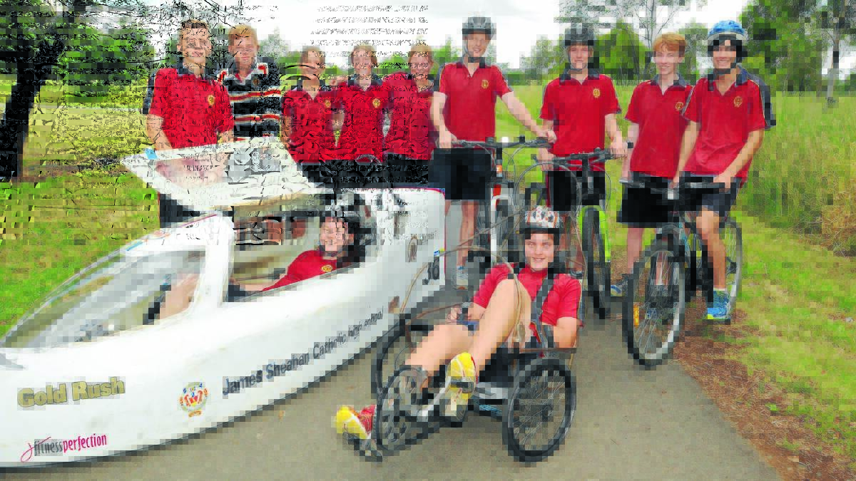 RACE READY: The James Sheahan Catholic High School human powered vehicle team members Darcy McKenna, Kyle Pemberton, Lauren Crean, Grace Wright, Annalise Livermore, Brenton Showell, Jacob Wright, Harrison Pirie, Lachlan Joseph (front) Maddison Clifford and Liam Pluymers test the track at Gosling Creek.
 Photo: JUDE KEOGH 1202hpv
