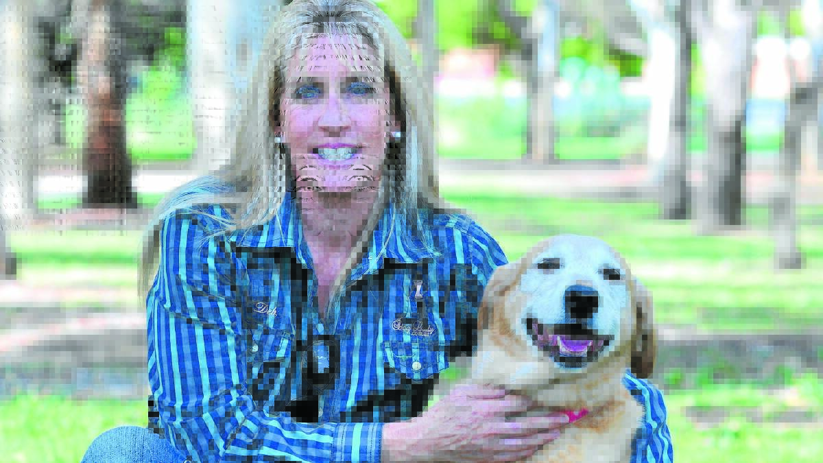 FOUR-LEGGED FRIENDS: Dog trainer Deb Coleman, with her dog Honey, says to reduce the number of dog attacks in Orange, dogs must be well socialised and people educated on dog body language. Photo: JUDE KEOGH 0224dogs1