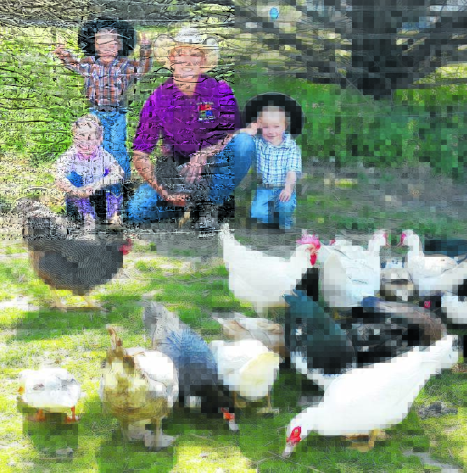 FEATHERED FRIENDS: Find And Seek Agriculture’s Lance Bonham with his brood Lachlan, Tayla and Beau, and also some poultry.