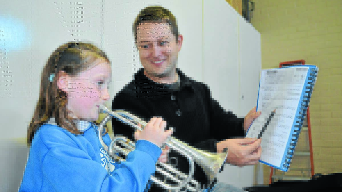 CALLING THE TUNE:  Elise Ciso and Matthew Gately practise at the Just Brass class. Mr Gately said Elise had come a long way in just three weeks. Photo: NICOLE KUTER 0331nkmusic
