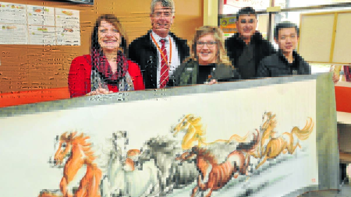 RUNNING WILD: Orange City Council migrant support officer Anni Gallagher, tourism manager Glenn Mickle, community development officer Lynda Bowtell, festival director and The Canobolas Rural Technology High School community liaison and partnerships officer Vince Lovecchio and Chinese delegate Chi Yulong show off the type of artwork to be exhibited during the 2015 Orange Youth Arts Festival.
 Photo: JUDE KEOGH  
