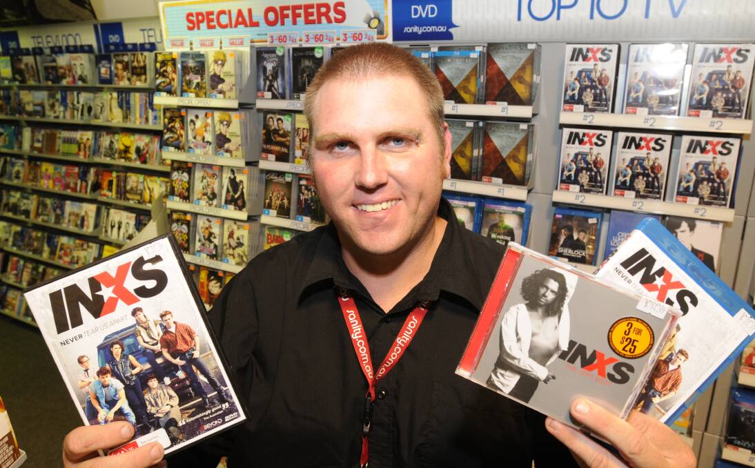 ONE FOR THE RECORDS: Staff at Sanity Music in Orange have been run off their feet with sales of INXS CDs and DVDs. Sanity part-time team leader Nick White has some of the INXS merchandise that’s been popular. 
Photo:STEVE GOSCH
