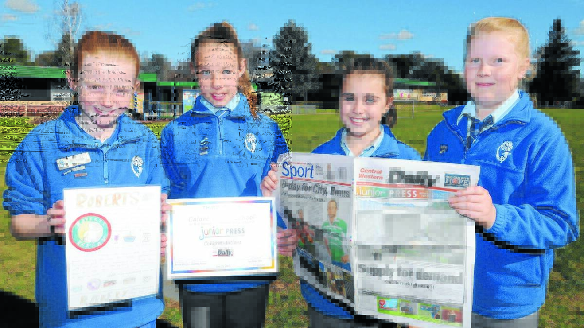 WORK OF ART: Calare Public School students Sally Eslick, Monique Burns, Annie Sidlo and Sarah Patton with their third placed ad they designed for the Junior Press competition. Photo: STEVE GOSCH  
