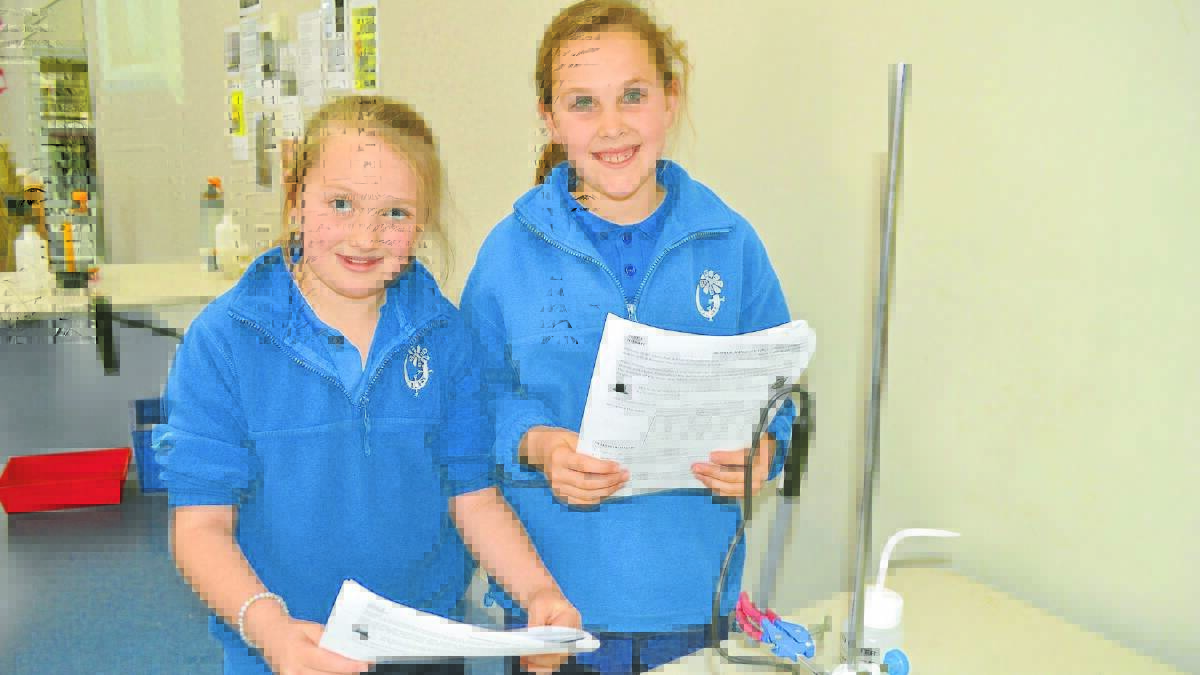 ENVIRONMENTAL EXPERIMENT: Calare Public School students Rhian Willoughby and Abby Sell tested nitrate levels during a CSIRO workshop at the Orange PCYC on Friday. Photo: TANYA MARSCHKE  
