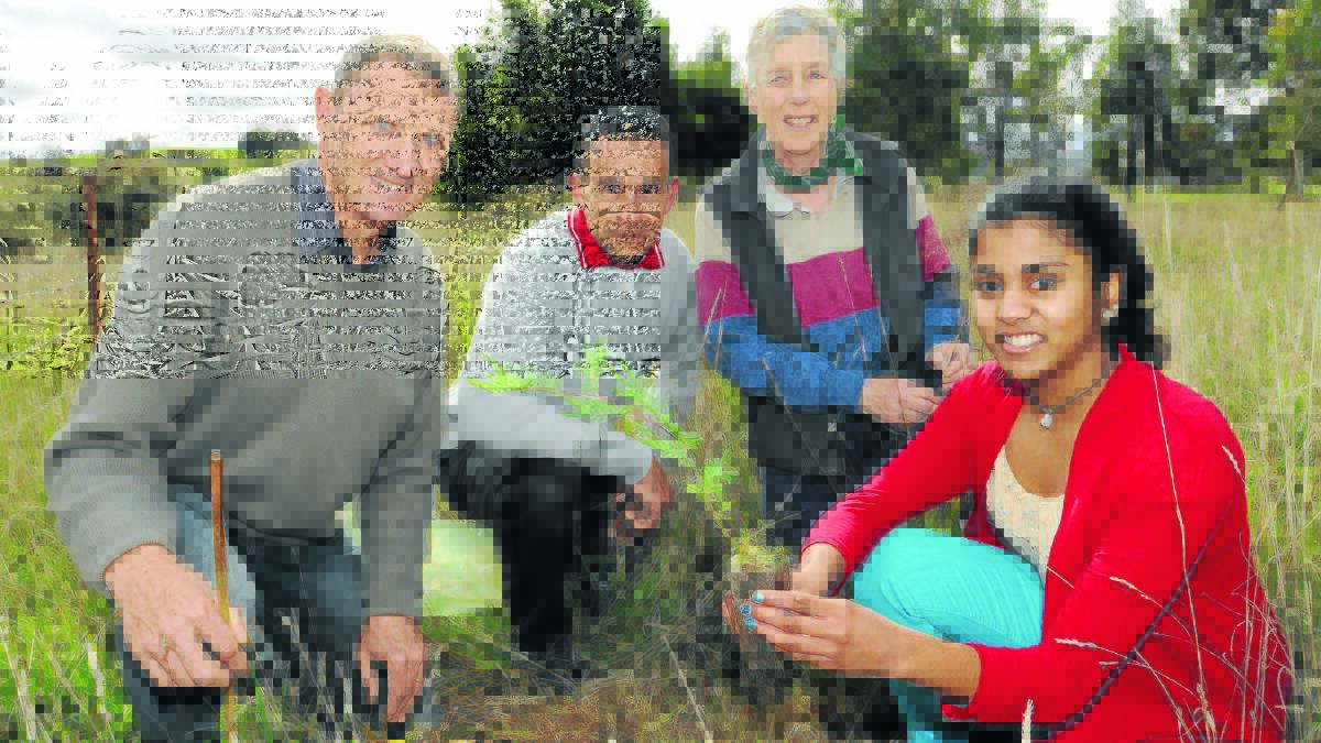 
GREEN THUMBS: Charles Sturt University Orange facilities management staff Mark Chapman and Nathan Totten, school of agriculture and wine sciences lecturer Dr Cilla Kinross and student Aranee Manorathan helped plant 140 trees, shrubs and ground cover plants on Friday. Photo: STEVE GOSCH