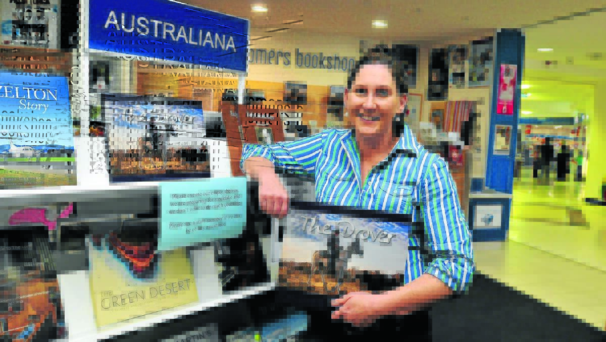 LIFE ON THE LAND: Alice Mabin with her new coffee table book The Drover. Photo: JUDE KEOGH                                                 0703book1
