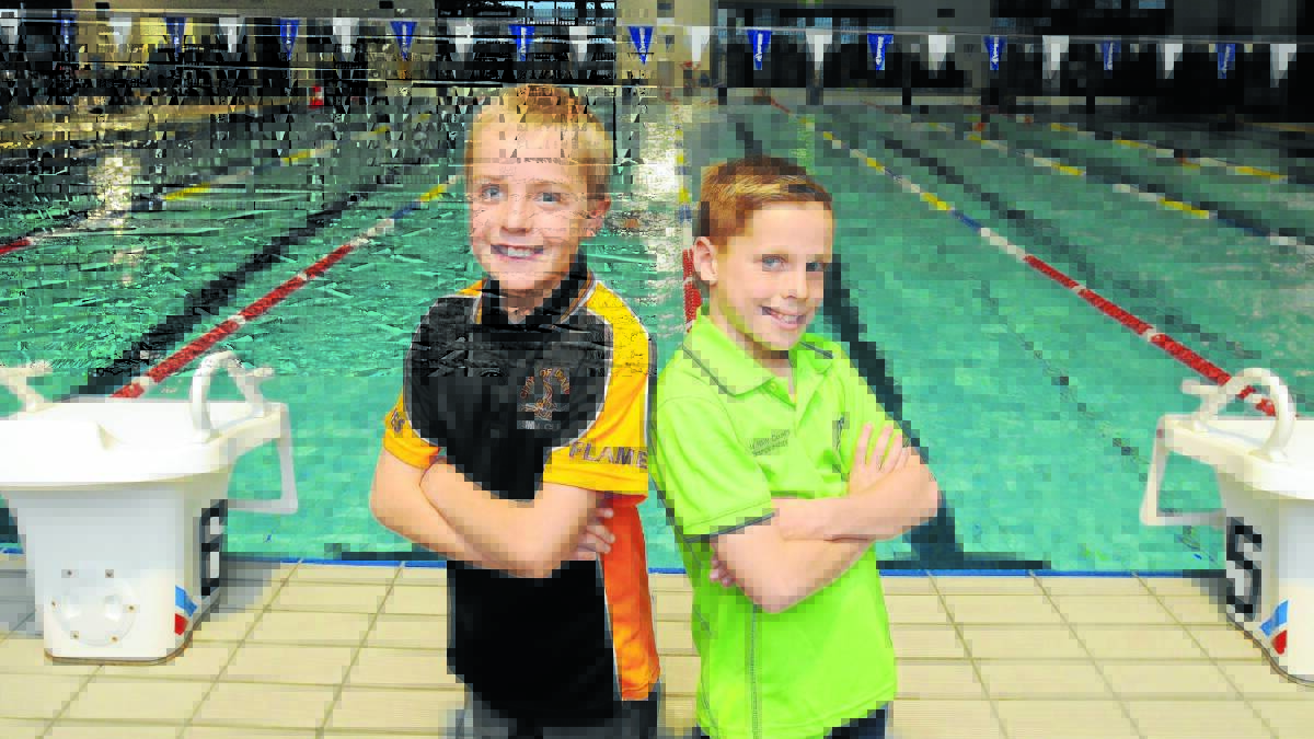 LAP OF LUXURY: Bradyn Nicol and Hugh Thornhill come in from the cold to the heated indoor pool at  Orange Aquatic Centre. Photo: Steve Gosch