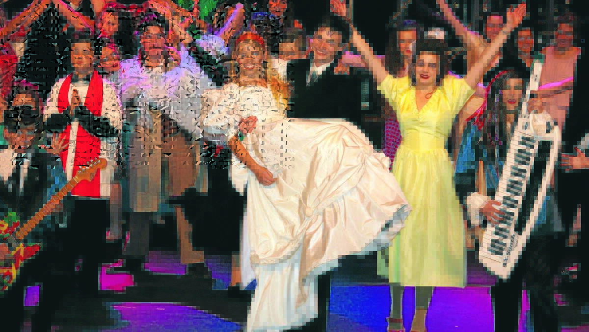 PARTY LIKE IT’S 1985: Joshua Cheney and Alice Litchfield star as Robbie Hart and Julia Sullivan in Kinross Wolaroi School’s production of The Wedding Singer. Photo: CONTRIBUTED
