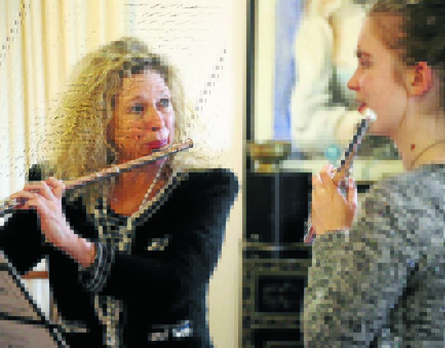 BLOW BY BLOW: Internationally renowned flautist Jane Rutter gives a lesson to Orange flautist Rhoslyn Carney during a visit to Orange last week.
Photo: PHIL BLATCH 