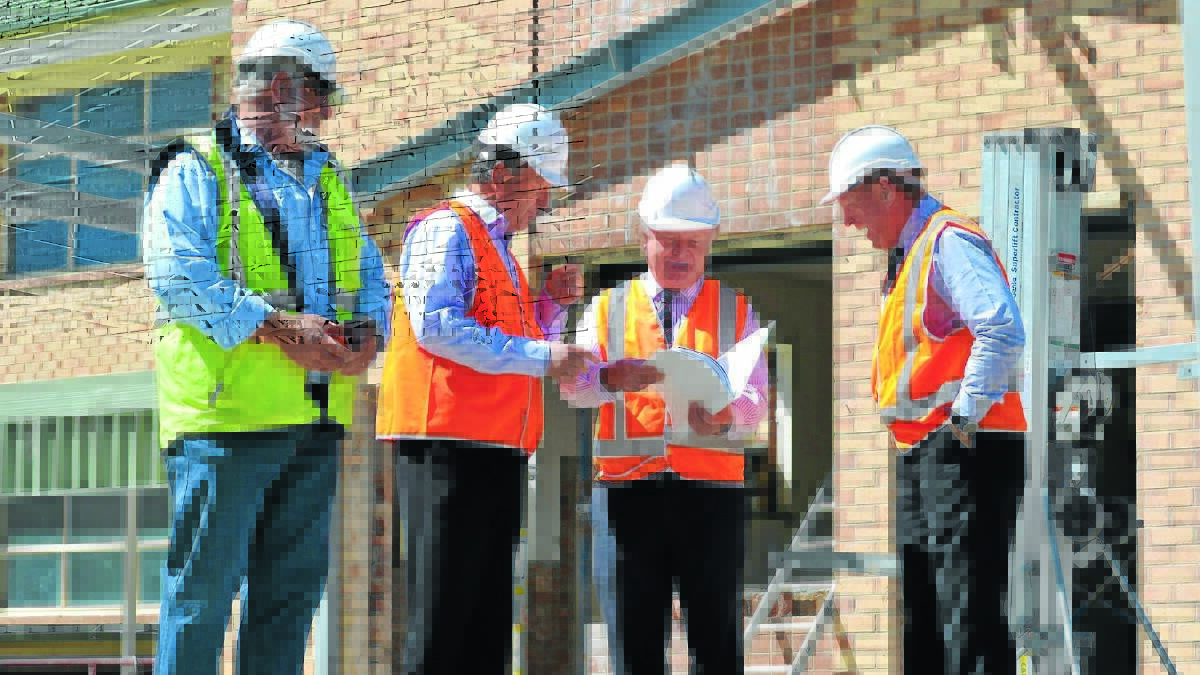 MODERN LEARNING: Site manager Robert Halcro, principal Michael Croke, head of administration Brian Morrissey and assistant principal Steve Maguire discuss the plans that will bring Catherine McAuley Catholic Primary School into line with elite schools across the country. Photo: NICOLE KUTER                                                                                              1028nkmcauley