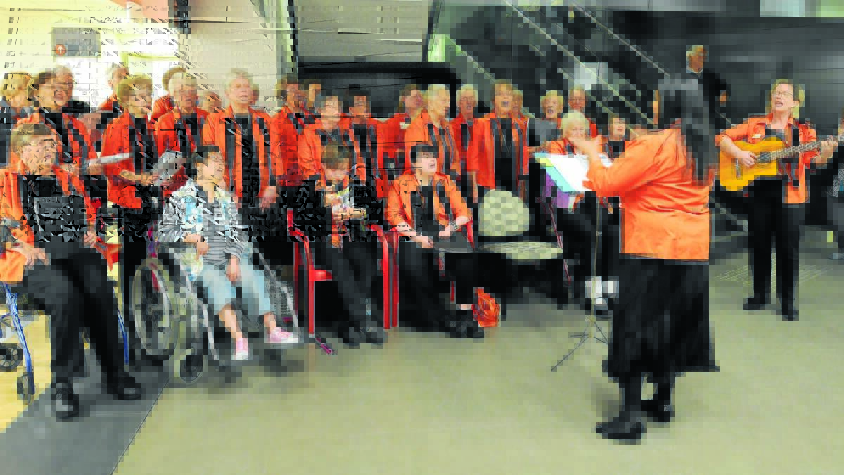COME TOGETHER RIGHT NOW: The Come Together Choir conducted by Samantha Bartholomeusz with director of Orange Regional Conservatorium Donna Riles providing guitar accompaniment, entertain visitors, patients and staff at Orange hospital. Photo: STEVE GOSCH
