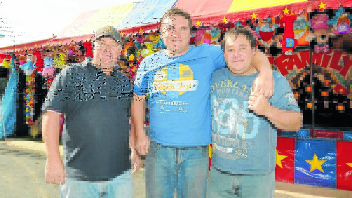 SHOWMEN: Mark Eade, Tyrone Miller and their uncle Perry Quay have between them 70 visits to the Orange Show following on from a long tradition in their family. Photo: STEVE GOSCH 