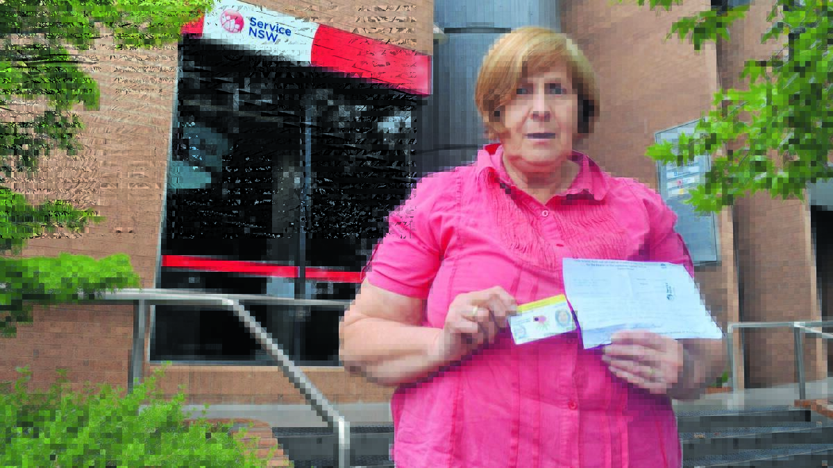 KEEP CARDS CLOSE: Helen Mulholland could be waiting a fortnight with no photo ID until her renewed driver’s licence arrives in the mail after a state government decision to introduce centralised card printing. 
Photo: CLARE COLLEY 0326cclicence1