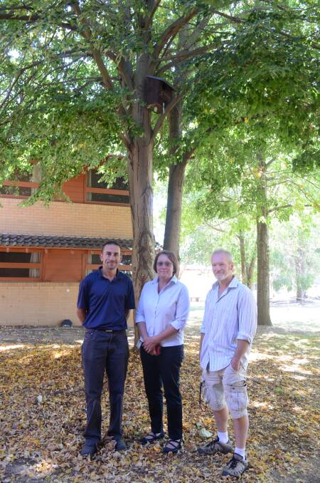 RIGHT OUT OF THE BOX: Charles Sturt’s Nathan Totten and  Therese King from division of facilities management with lecturer and head of campus environmental commitee Scott Andrew show off on of the possums’ new homes. Photo: JUDE KEOGH