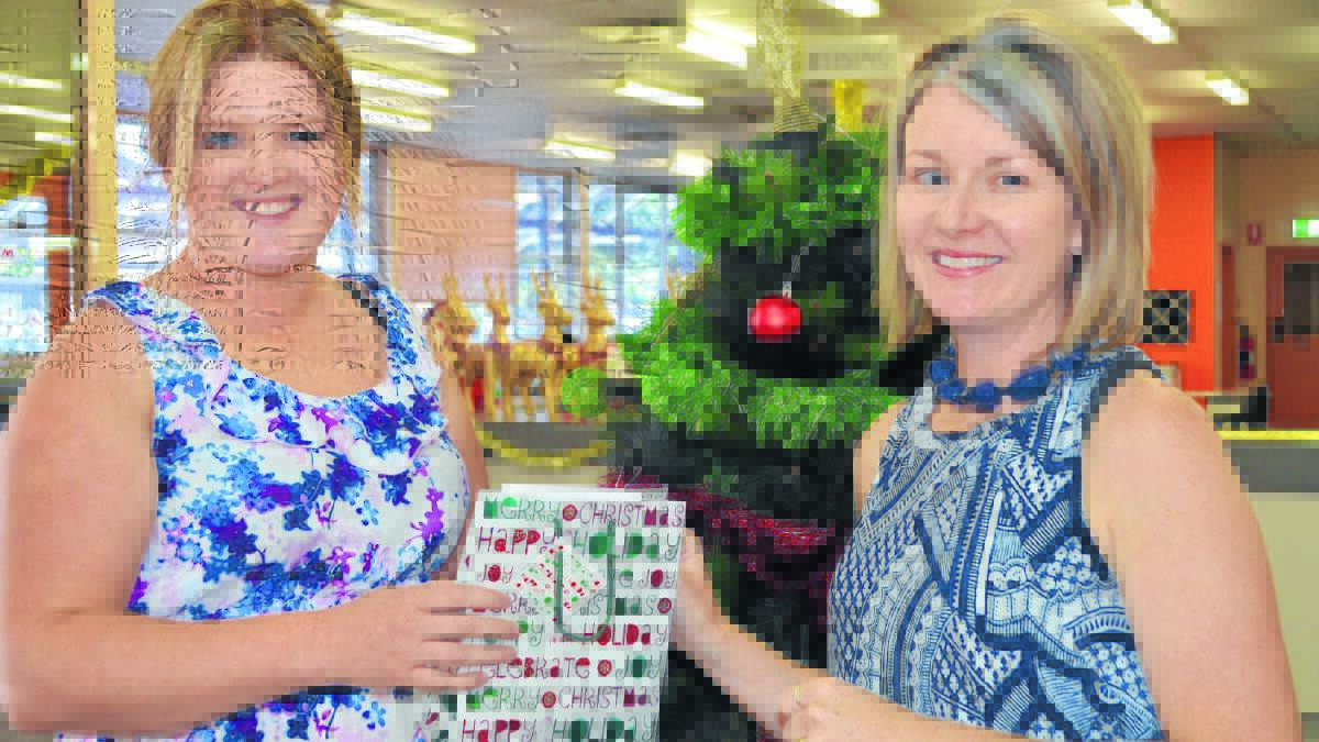 EARLY CHRISTMAS PRESENT: Central Western Daily account assistant Sharni Whiteley presented Sarah Buckingham with her Shop Local and Win prizes from the fourth prize draw. Photo: TANYA MARSCHKE  1215shoplocal1.

