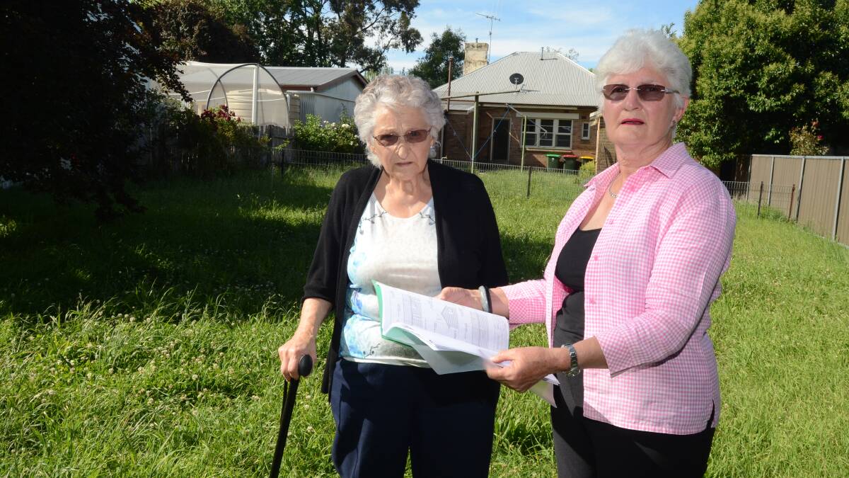 NEIGHBOURLY CONCERNS: Lords Place residents Barbara Woodley and Lee Bell say they're concerned a proposed Dalton Street development is not in keeping with other buildings in the heritage precinct.                                                                                                                                    Photo: JUDE KEOGH 1130development1